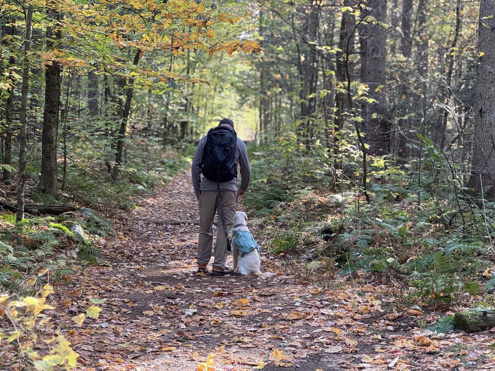 Rich and his dog Doc on a wooded hiking trail